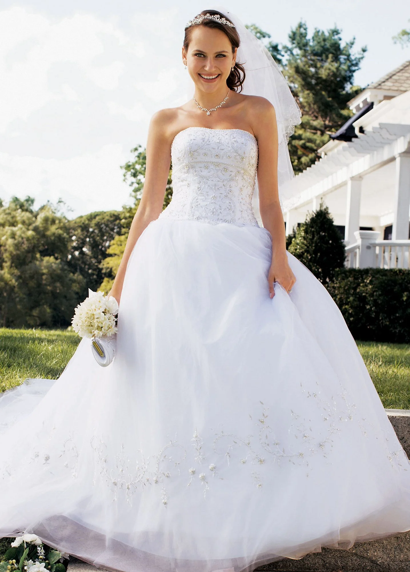 Tulle ball gown with empire bodice and beaded metallic lace on bodice and skirt.